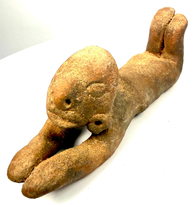 Pre-Columbian terracotta figure displaying sculptural characteristics associated with Chorrera ceramic traditions, including exaggerated proportions and ear ornaments.