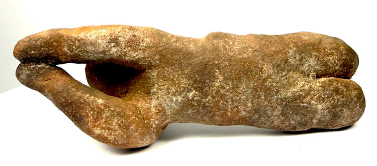Ecuadorian-style terracotta human figure featuring a weathered surface, mottled discoloration, pale mineral-like deposits, and darker recessed areas.