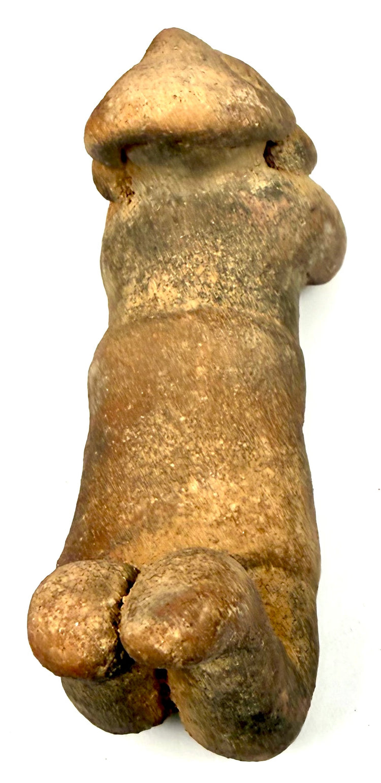 Pre-Columbian anthropomorphic earthenware sculpture with raised bent legs, visible linear fissures, surface abrasions, and granular texture.