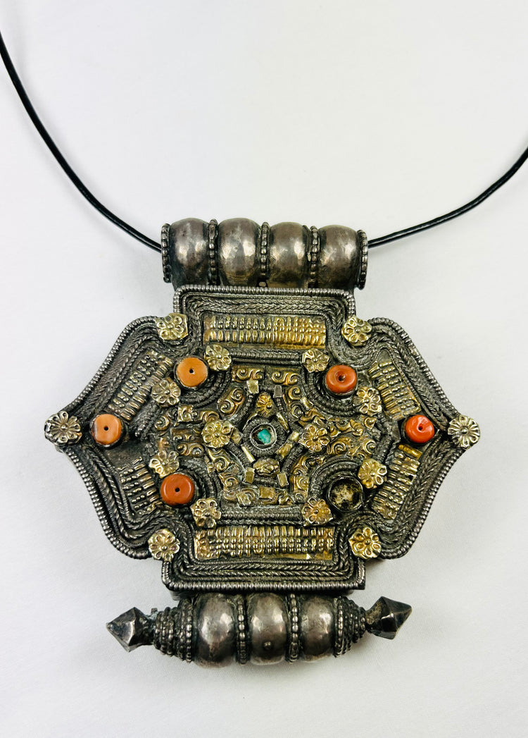 Silver-tone Himalayan gau pendant, filigree, rosette appliqués, coral and turquoise insets, 19th–20th c.