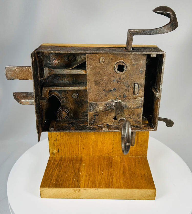 Mechanical door lock with exposed inner workings mounted on display base