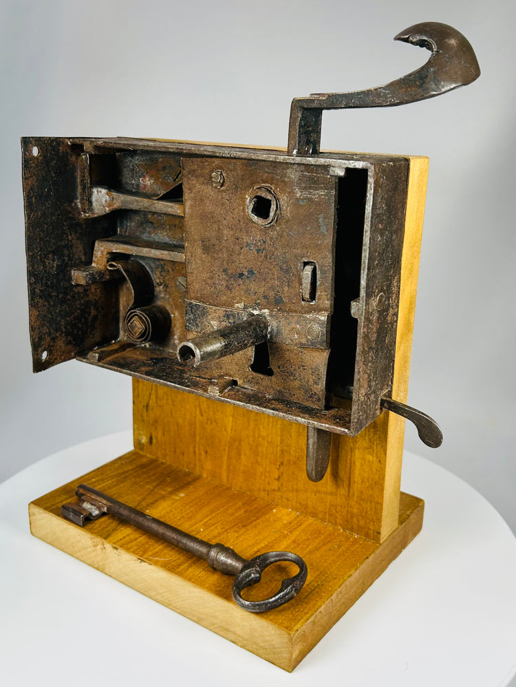19th century hand-forged iron lock with multi-bolt system and display stand