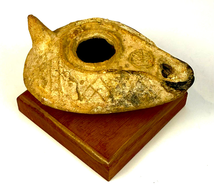 Late Roman–Early Byzantine earthenware oil lamp featuring a slipper-shaped body, elongated wick nozzle, and conical rear handle.