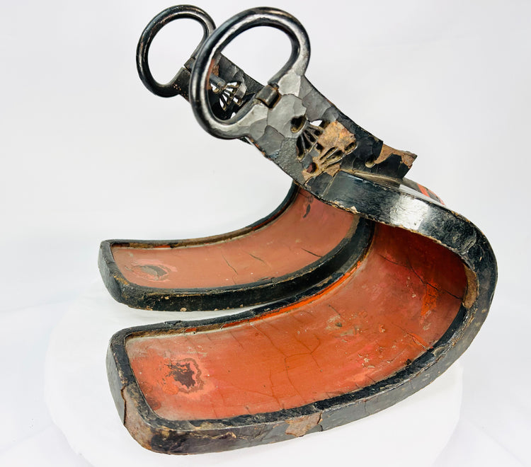Pair of antique Japanese lacquered samurai stirrups with curved red interiors and black lacquered exteriors, Edo–Meiji period craftsmanship, displayed on a white background.