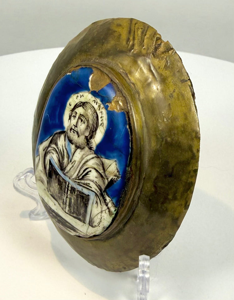 Russian Orthodox Gospel-cover ornament featuring a bearded Evangelist with delicate facial detailing and a partially preserved Cyrillic halo inscription.