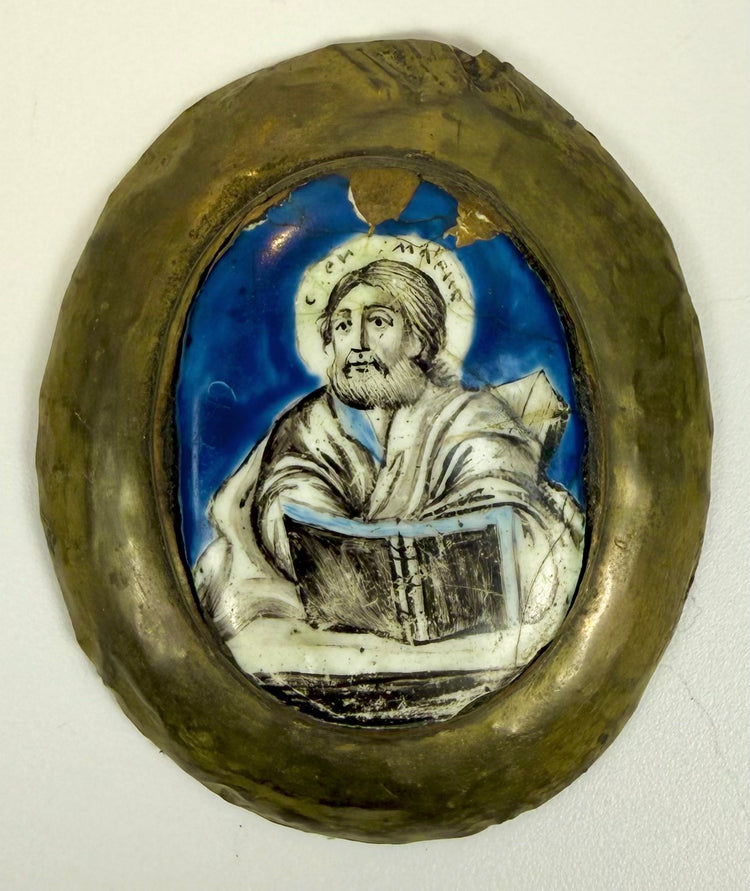 Russian Orthodox painted enamel icon featuring visible cracks, chips, and enamel losses along the upper cobalt-blue background and surrounding metal frame.