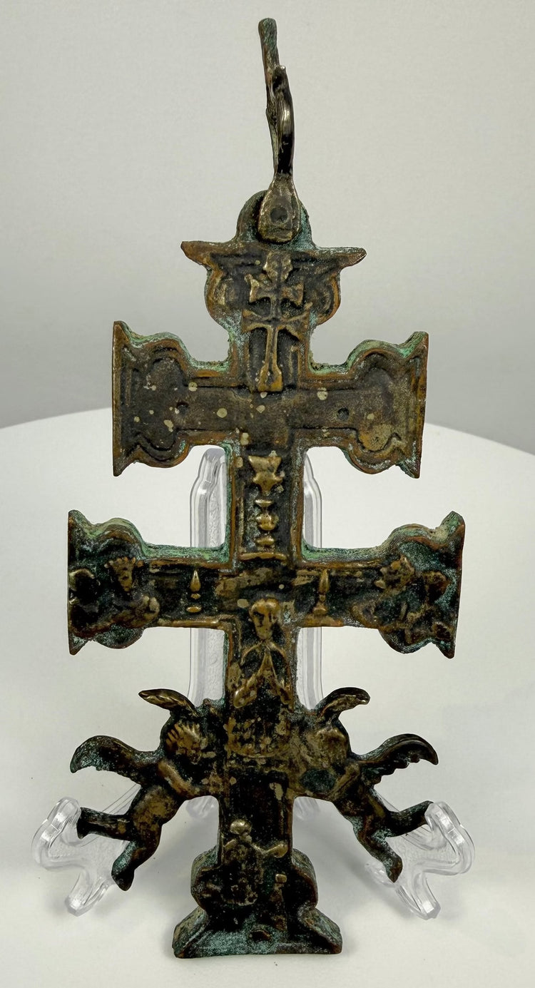 17th-century Spanish bronze Caravaca crucifix featuring the Crucifixion of Christ, Marian devotional imagery, and two sculpted winged angels.