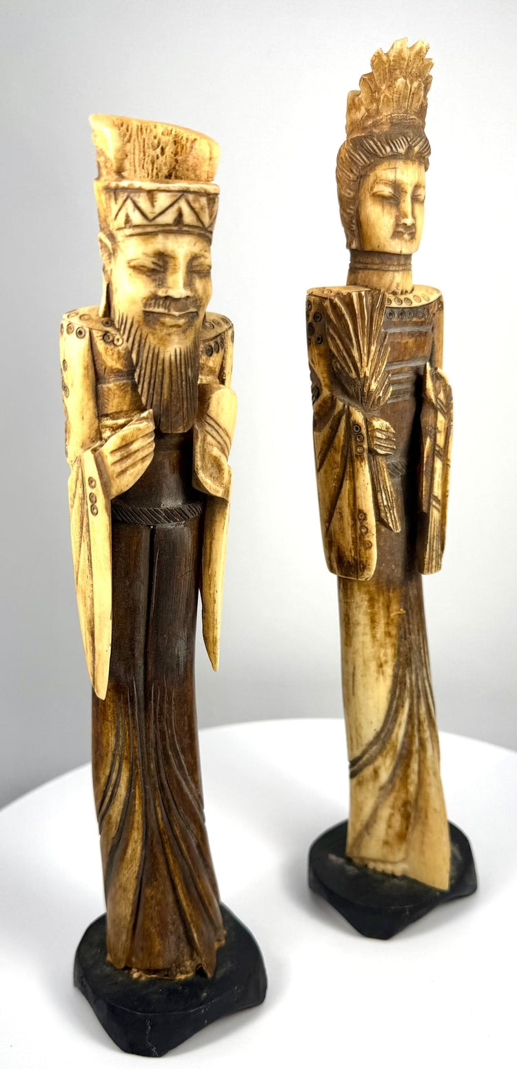 Vintage Chinese Emperor and Empress sculptures showcasing complementary imperial-inspired clothing, elongated figures, and detailed decorative carving.