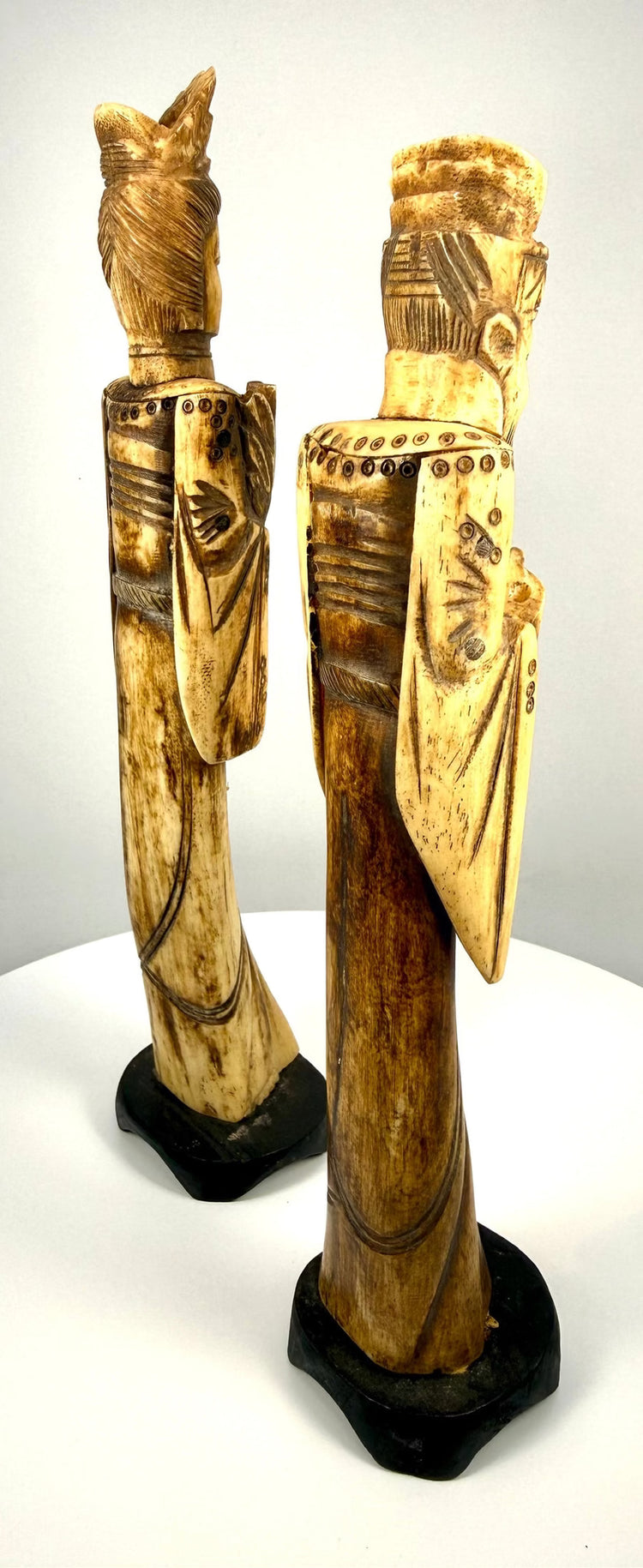 Chinese carved-bone Emperor sculpture displaying a textured headdress, long flowing beard, ornamental sleeves, and natural cream-coloured bone.