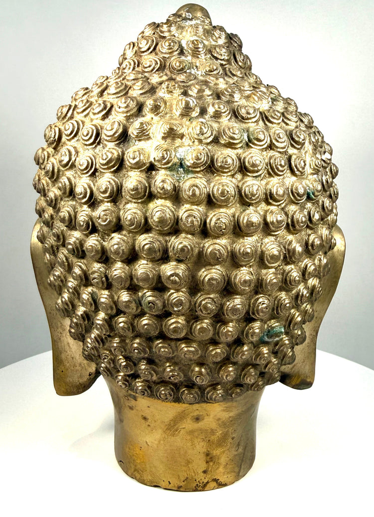 Asian Buddhist metal sculpture displaying rows of tightly arranged hair curls extending across the crown and surrounding the raised ushnisha.
