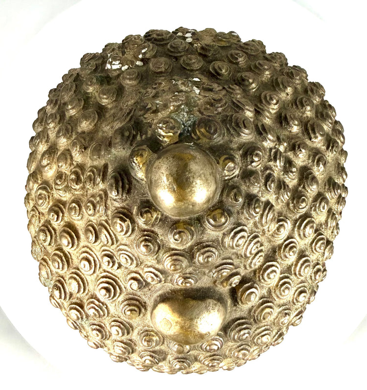 Vintage Buddha head sculpture displaying natural surface discoloration, scattered abrasions, darkened recesses, and areas of greenish copper oxidation.