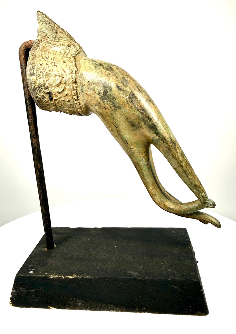 Antique Southeast Asian Buddhist hand sculpture displaying natural bronze patination, surface abrasions, detailed floral reliefs, and traditional religious symbolism.