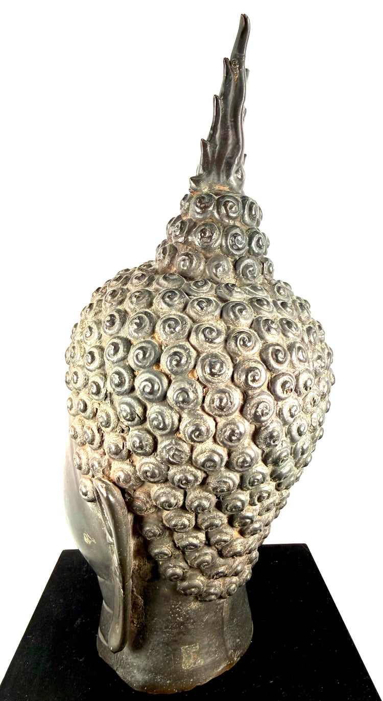 Buddha sculpture with softly defined lips forming a gentle meditative smile, reflecting traditional Thai Buddhist artistry.