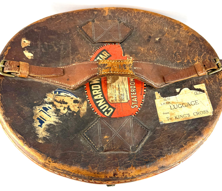 Antique brown leather travelling case displaying substantial historic patination, surface cracking, and worn edges.