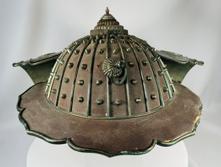 Historic Japanese helmet with decorative engraving and textile interior lining