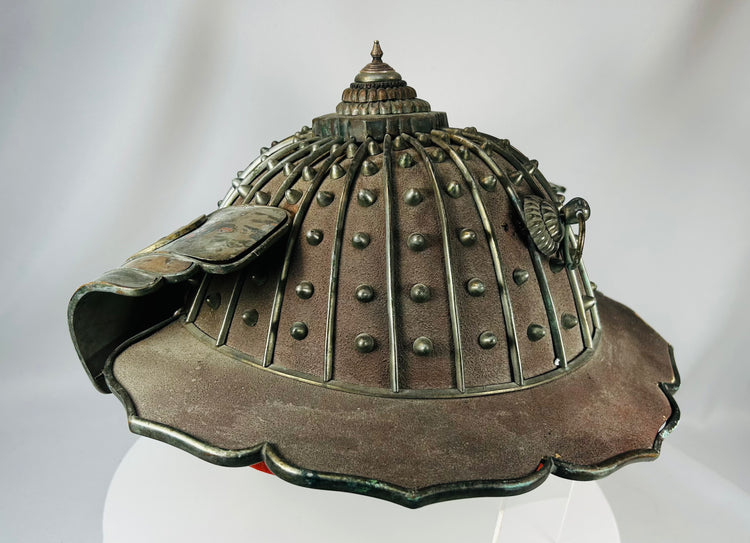 Antique Japanese firefighter helmet with multi-tiered crown finial and patina