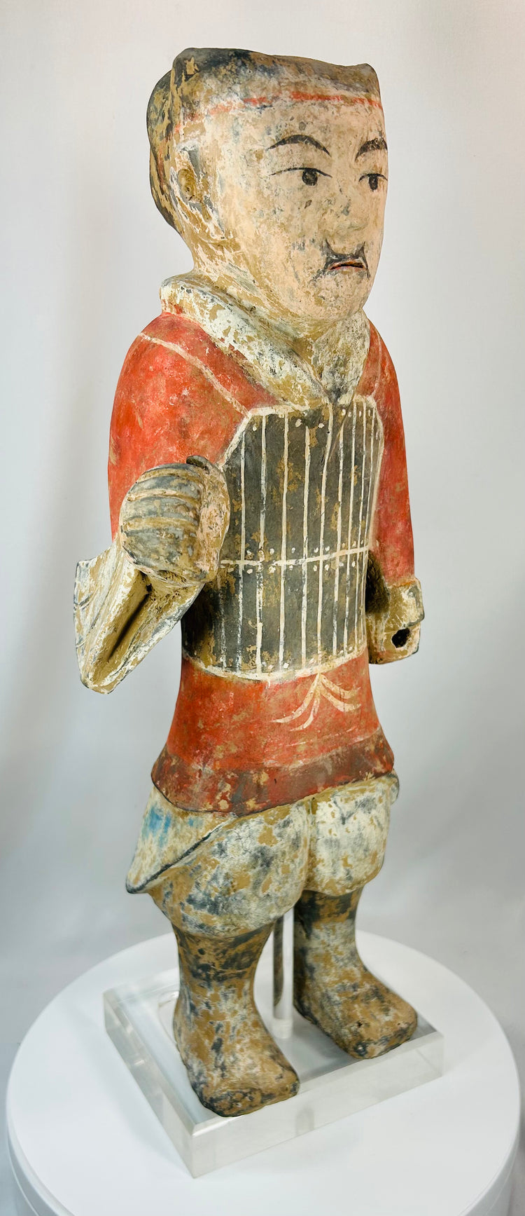 Chinese funerary terracotta warrior figure with stylized armor and painted features
