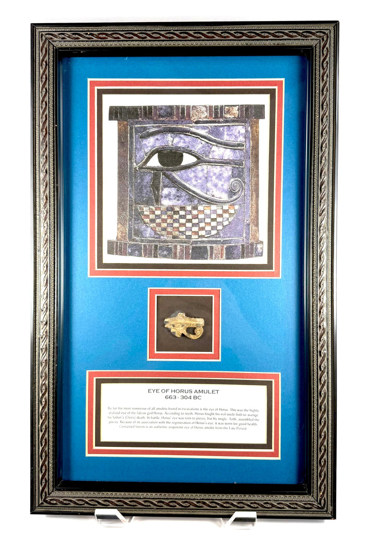 Framed Egyptian Wedjat Eye amulet carved from soapstone, featuring protective symbolism from the Late Period to Early Ptolemaic Period.