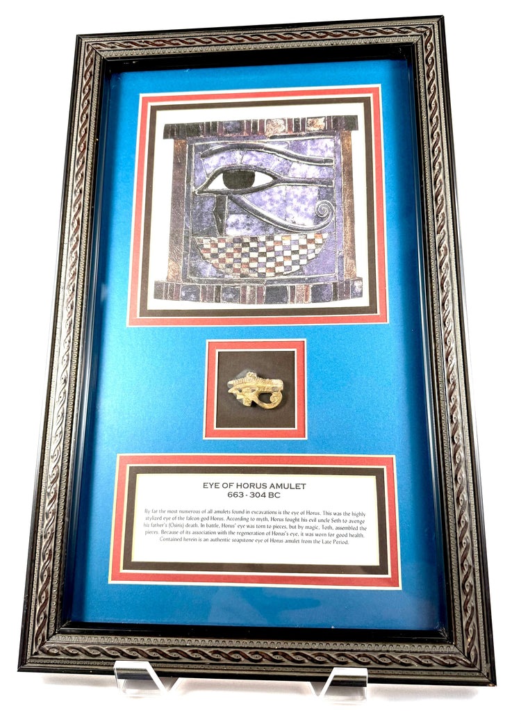 Ancient Egyptian Eye of Horus artwork with falcon-inspired markings against a deep blue-purple background in an ornate black frame.