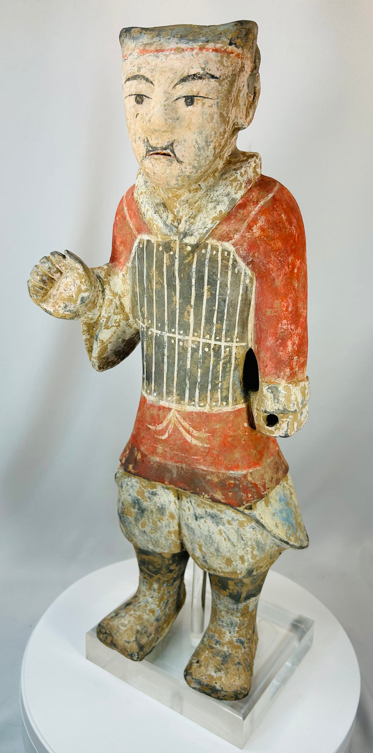 Han period terracotta warrior with expressive face and preserved paint remnants