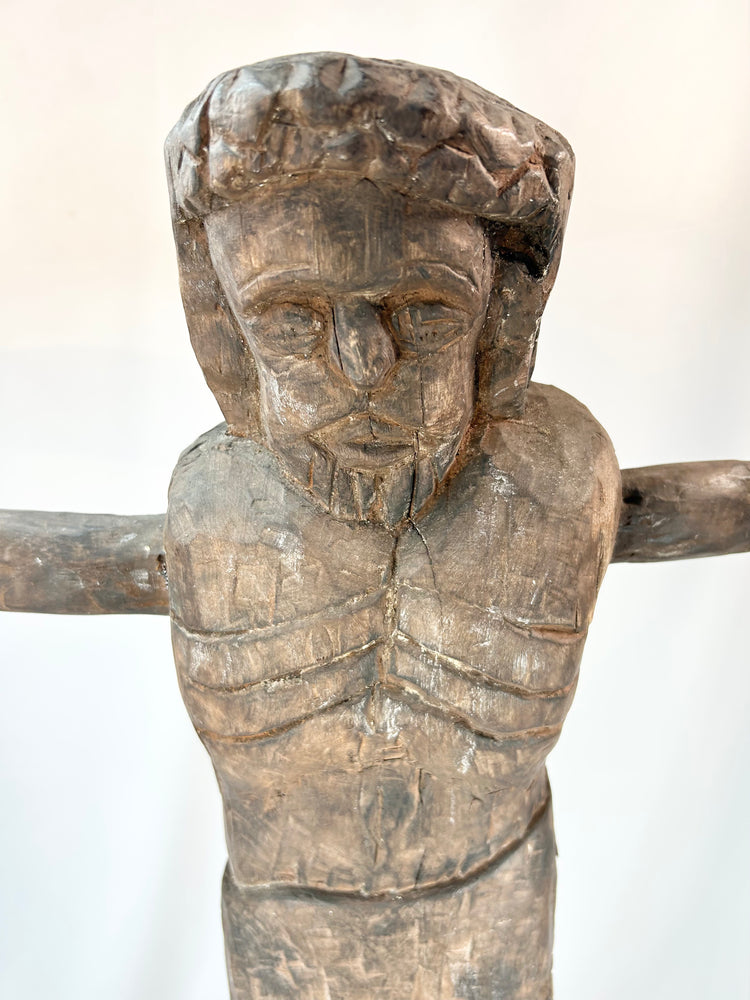 Latin American carved Christ figure with elongated form and expressive features