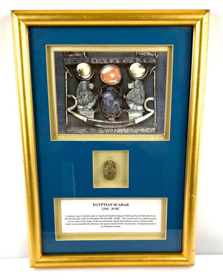 Egyptian scarab beetle amulet with turquoise-green glazed surface, brown markings, and traditional religious symbolism.