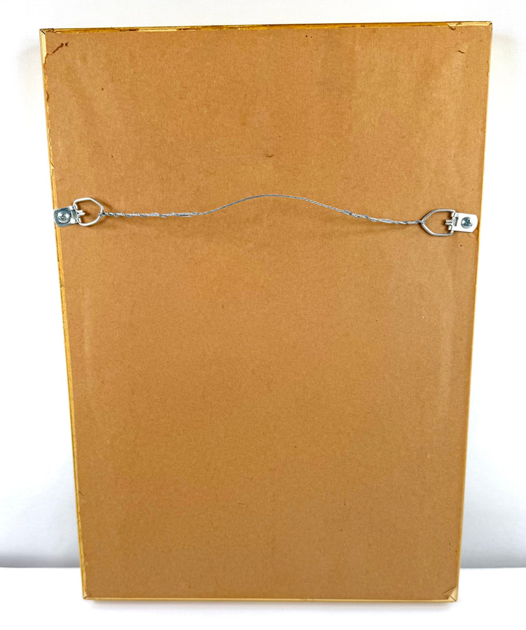 Reverse of a framed Egyptian scarab amulet display featuring the original backing board, hanging wire, and mounting hardware.