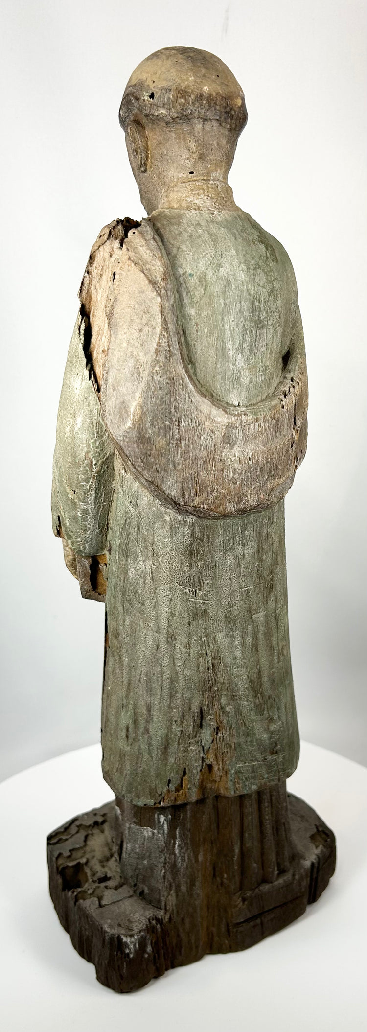 Antique santo figure with extended arm and scripture book detail