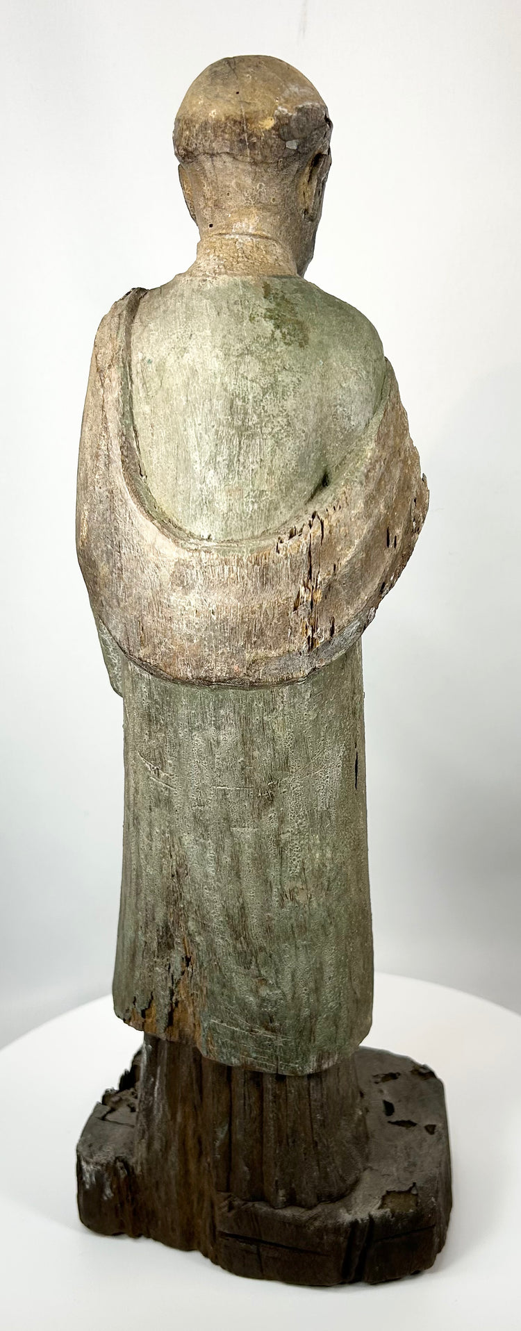 Hand-carved religious santo with worn paint and historic surface wear