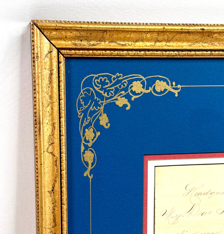 Ornate gold-finished frame detailing surrounding the William Tecumseh Sherman historical display, featuring raised decorative patterns and blue matting.