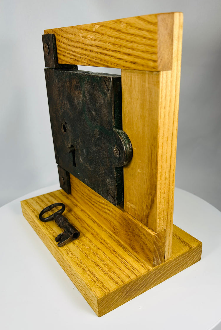 Rustic iron door lock with original key and visible tool marks
