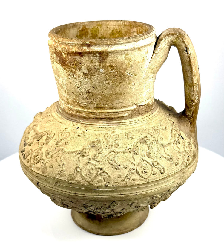 Twelfth–thirteenth-century Islamic pottery vessel featuring repeating animal motifs and ornamental patterns around the rounded shoulder.