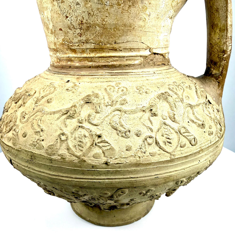 Short flared circular foot of a medieval Islamic ceramic ewer, showing concentric forming marks, surface deposits, and historic wear.