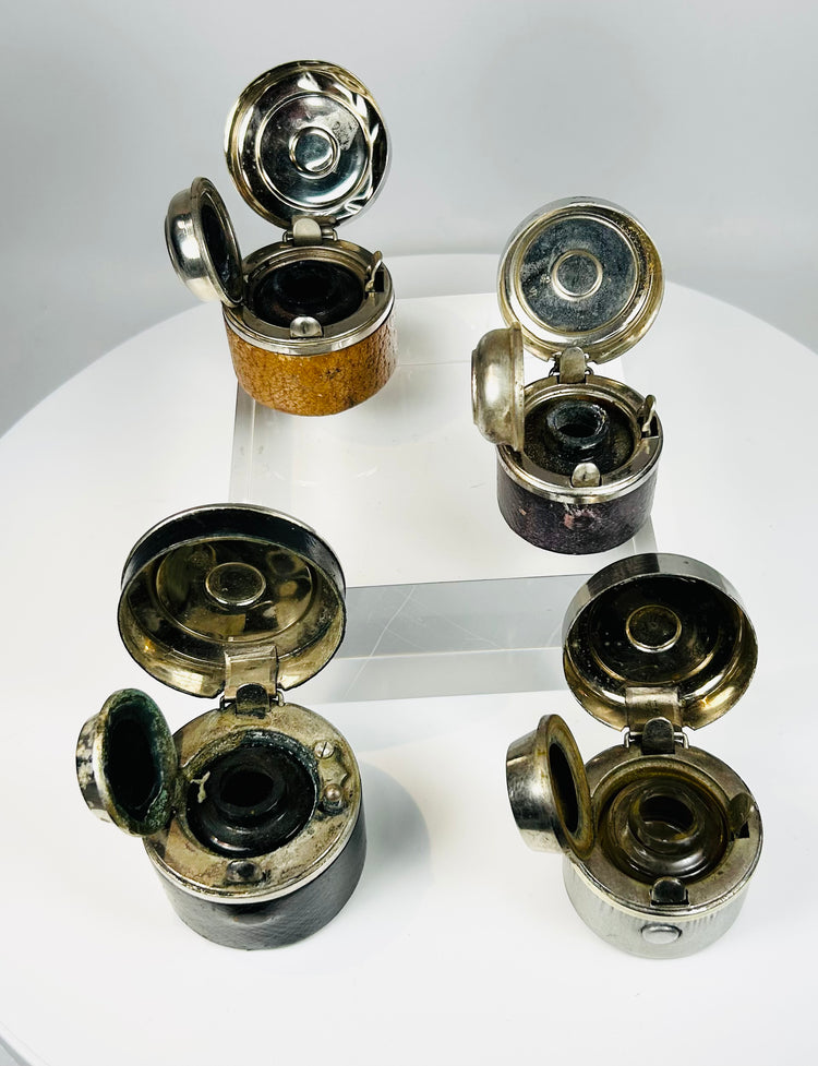 Collectible antique inkwells set showing age wear and historic use