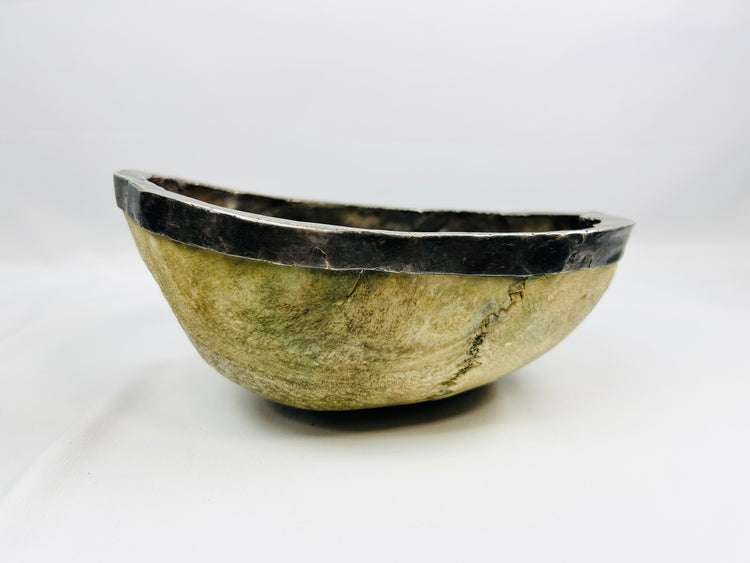 19th-century Tibetan Kapala ritual skull cup showing human bone bowl with silver rim, used in Tantric Buddhist ceremonies.