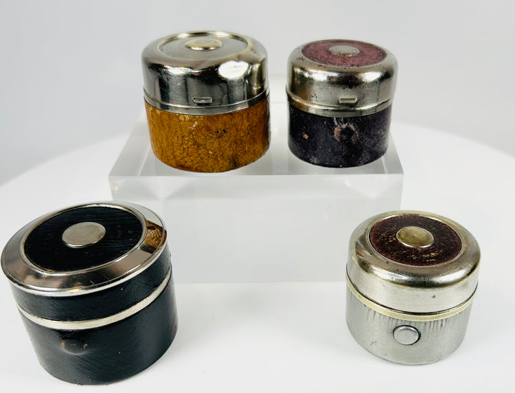Leather-wrapped antique inkwells with aged patina and compact design