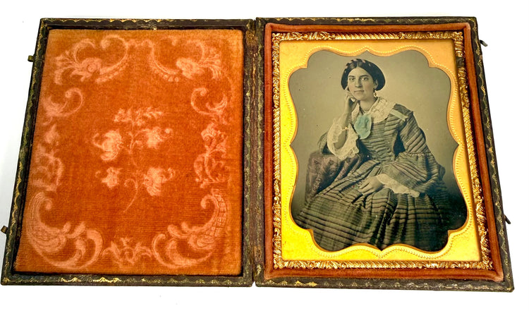 Antique Victorian photographic portrait depicting a woman with dark hair, decorative lace collar, and formal studio attire.