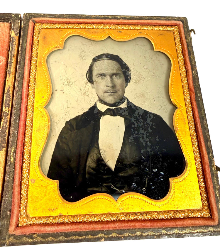 Early American cased photographic portrait with an elaborate gilt-metal surround and richly decorated velvet interior, circa 1855–1865.