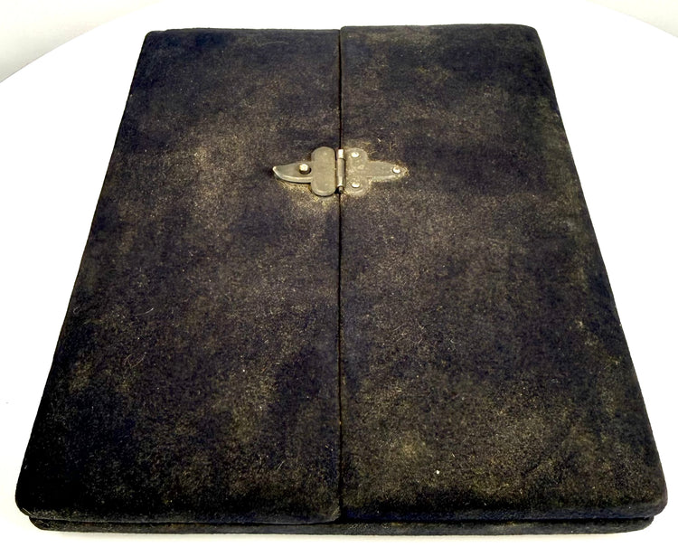 Closed late Victorian black velvet-covered photographic presentation case with decorative metal fastening, circa 1895–1915.