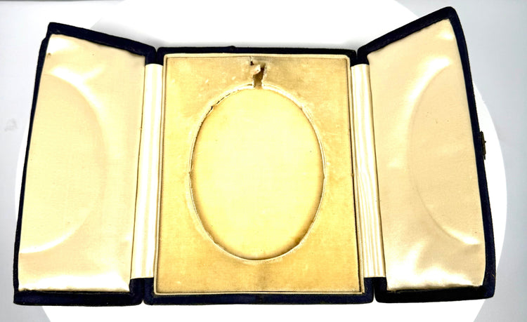 Late Victorian to Edwardian photographic keepsake showing a woman's side-profile portrait within an open three-panel display case.