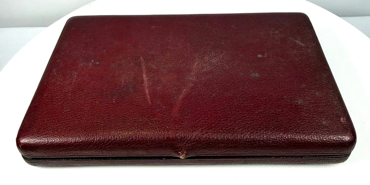 Closed Victorian–Edwardian burgundy leather portrait case featuring a rectangular design, aged exterior finish, and metal fastening.