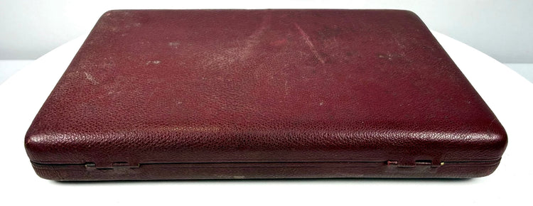 Antique double portrait presentation case shown closed, displaying its burgundy leather covering and gently worn edges.