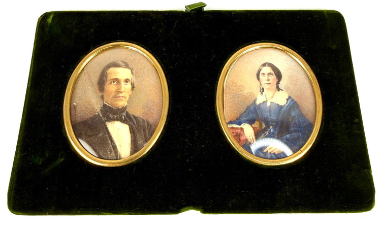 Removable double portrait panel featuring colour miniatures of a gentleman and woman in gilt-coloured oval frames against dark green velvet.