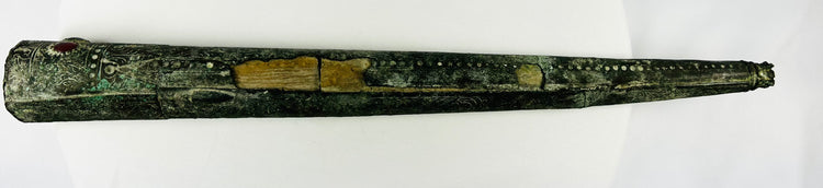 Close-up of the open end of an ancient bronze sword sheath showing interior structure and burial patina from early Etruscan Italy, circa 900–700 BCE