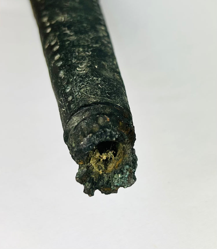 Middle section of engraved bronze sword sheath featuring red gemstone inlays and incised decoration from ancient Etruria (Italy), circa 900–700 BCE