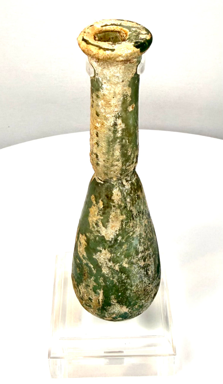 Antique Roman green glass perfume bottle with an elongated cylindrical neck and thickened, outward-flaring rounded lip.