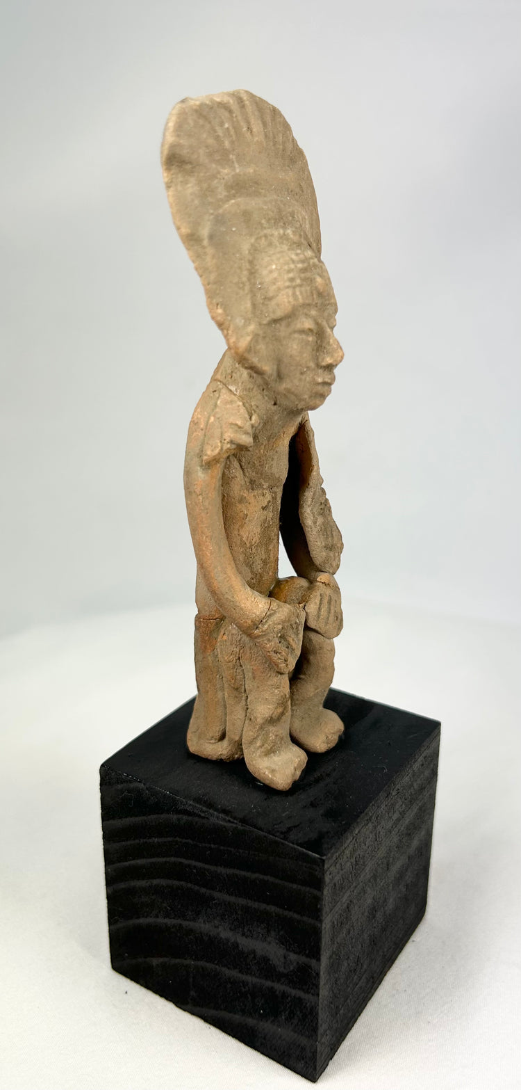 Terracotta standing figure with tall radiating headdress, abstract features, Nayarit or Jalisco