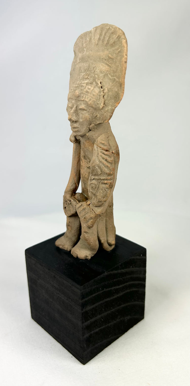 Pre-Columbian terracotta standing figure with headdress, West Mexico, 300 BCE–500 CE, display-mounted
