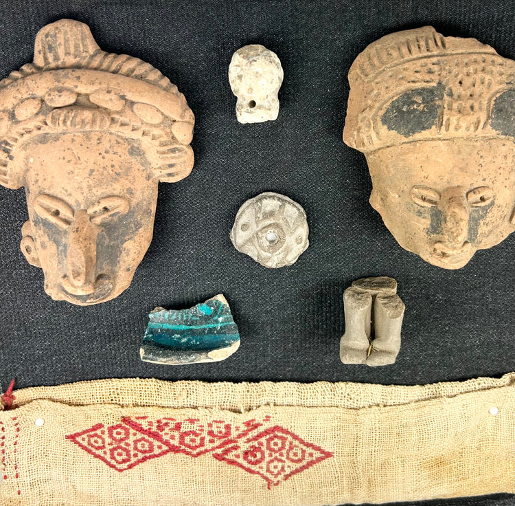 Pre-Columbian terracotta fragments and red geometric textile, framed in shadowbox for display