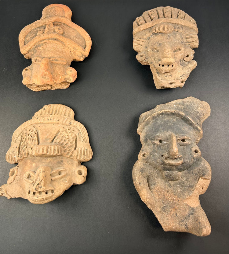 Pre-Columbian mask and face fragments, mounted together on white background